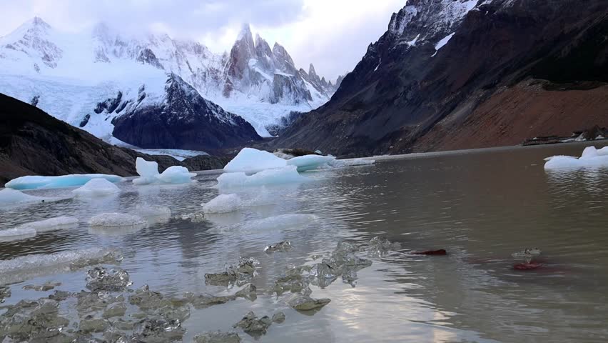 Cerro Torre mountain summit and lake in the Andes Patagonia. El Chalten trekking to laguna Torre in Argentina patagonia mountains. Hiking to the lake with the icebergs falling from the glacier