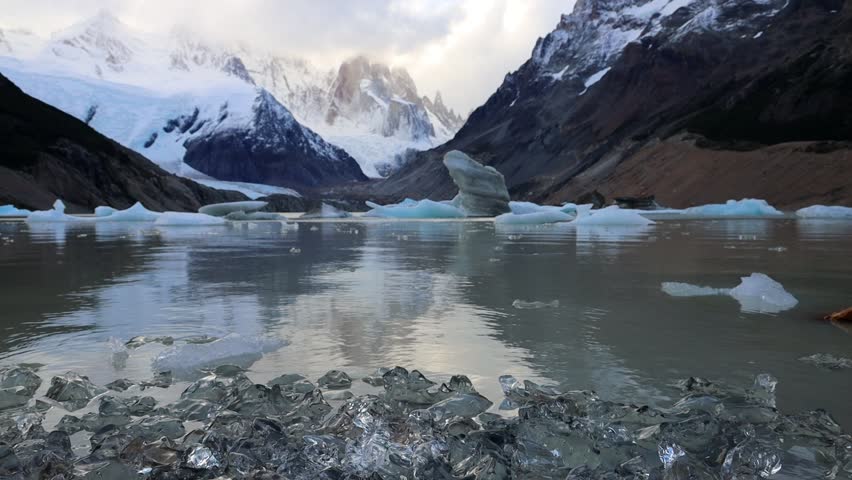 Cerro Torre mountain summit and lake in the Andes Patagonia. El Chalten trekking to laguna Torre in Argentina patagonia mountains. Hiking to the lake with the icebergs falling from the glacier