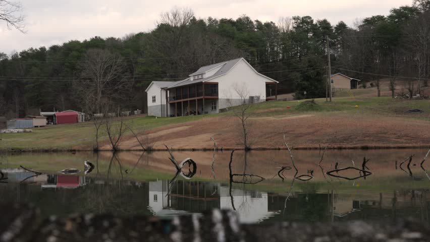 Timelapse of Clouds Moving Above House with Pond