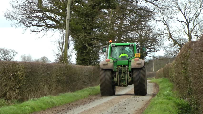 Tractor Driving On A Country Lane