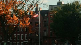 Us flag in the wind in Copps Hill Burying Site at sunset with fallen leaves during fall at slow motion, Boston, Massachussetts, United States of America - Powered by Shutterstock - Get 15% off with code: PIKWIZARD15