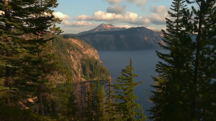 Static view of Mount Scott summit at Crater Lake, framed by pine trees. Oregon, USA