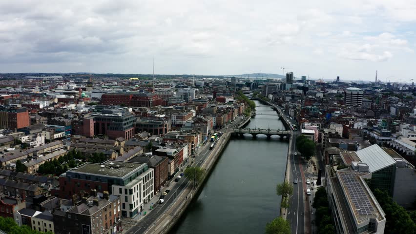 Drone shot of Dublin's Four Courts building perched on the River Liffey.