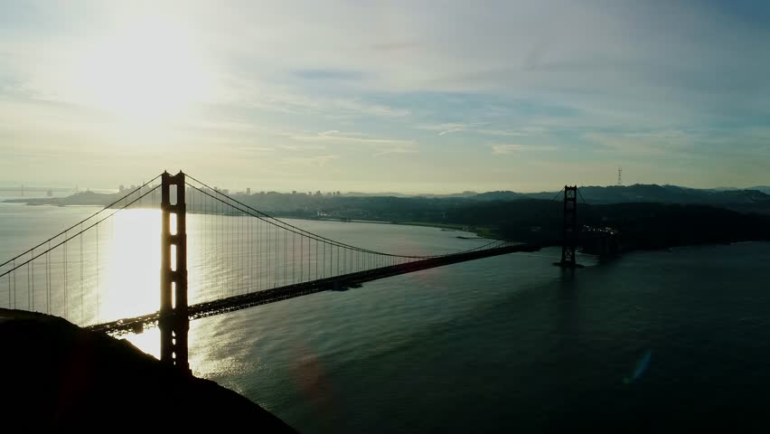 Golden Hour over Golden Gate Bridge, with shimmering water and skyline glow