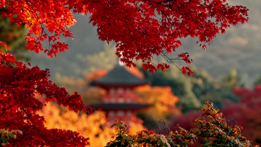 Iconic pagoda inKiyomizu-dera Temple in Kyoto, Japan, stands majestically against a golden sunset, surrounded by vibrant red and yellow autumn foliage.