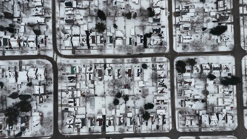 An aerial view of snow-covered neighborhood with calm streets around, during the winter season in Waterloo, Ontario, Canada