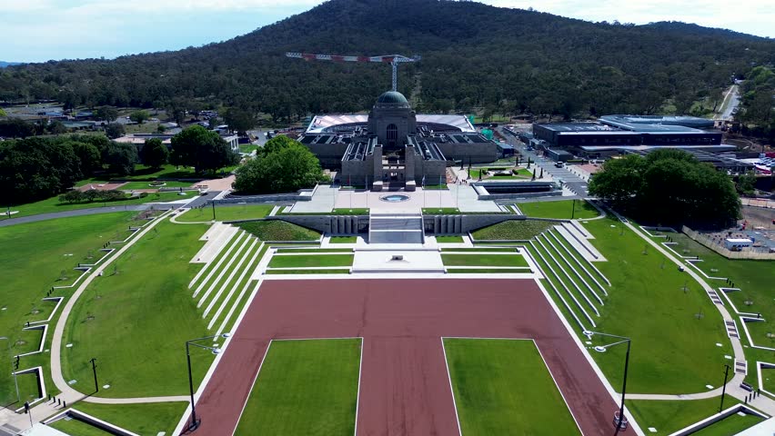 Drone aerial landscape of War Memorial museum building with front entrance stairs and crane development construction Canberra city capital ACT Australia travel tourism Anzac parade