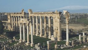 A breathtaking aerial view of the ancient Roman ruins in Tyre, Lebanon. The towering colonnade and remnants of the triumphal arch stand as a testament to the city's rich Phoenician and Roman heritage - Powered by Shutterstock - Get 15% off with code: PIKWIZARD15
