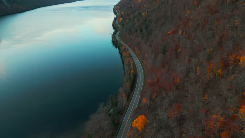 Aerial shot over a road on the side of Lake Willoughby at the end of autumn in Vermont, United States of America