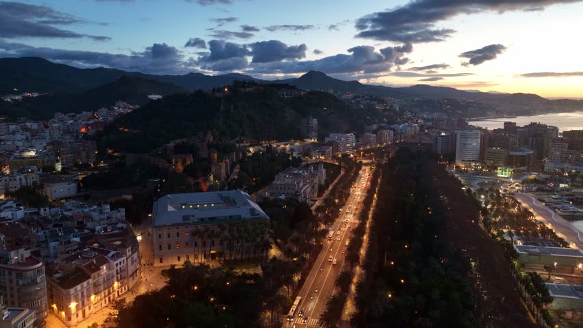 Drone shot of Malaga at night, Malaga castle with night illumination, Malaga city in Andalucia is a tourist destination in the southern Spain