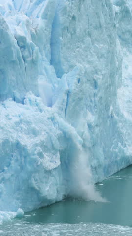 Vertical View, Ice Collapse From Glacier Into Lake. Climate Change and Global Warming Concept