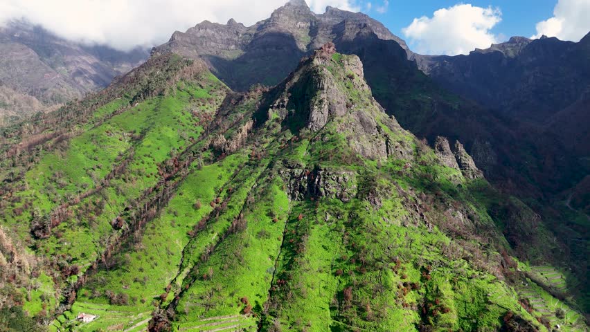 Aerial view from Miradouro da Terra Grande, with tall mountain peaks shrouded in white clouds, Madeira Island, Portugal