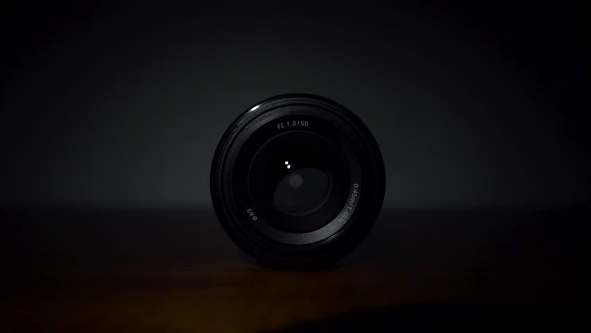 Lens in cinematic setting with focused aperture, capturing sleek and minimalistic look