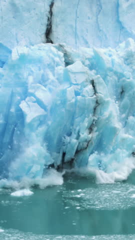 Vertical View, Glacier Ice Collapse Into Ocean Water, Close Up. Global Warming and Climate Change Concept