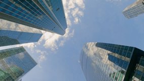 Modern skyscrapers against blue sky with clouds. Business center low angle view. Urban skyline. Corporate buildings. - Powered by Shutterstock - Get 15% off with code: PIKWIZARD15
