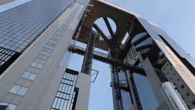 Umeda Sky Building in Osaka Japan and sunlight in evening. Landmark features a unique floating garden observatory connecting twin towers at top. Umeda Sky Building One of Osaka Landmark travel spot. - Powered by Shutterstock - Get 15% off with code: PIKWIZARD15