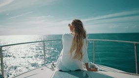 Trip to ocean by yacht, back view of happy female vacationer admiring seaview. Summer vacation, touristic excursion, fishing in open sea, woman looking to horizon, rearview, freedom and joy in summer - Powered by Shutterstock - Get 15% off with code: PIKWIZARD15