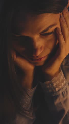 Young woman suffering from insomnia, she is sitting on bed and thinking, the clock shows it's morning