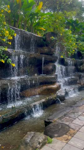 A charming human-made small fountain, surrounded by lush greenery, adding tranquility to the landscape.