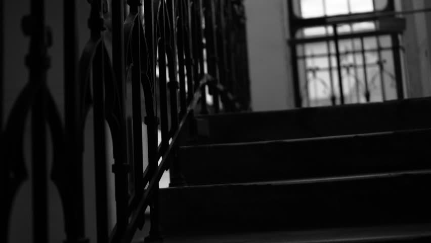 old staircase in the house, steps and railings. taken by hand. Climbing the stairs. The camera slides up the old stairs