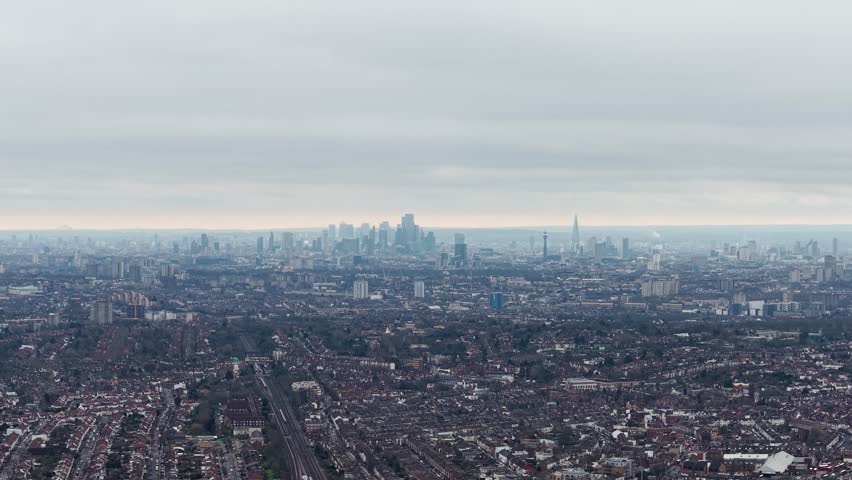 Aerial view overlooking London cityscape skyline in the distance from downtown Wembley city suburbs