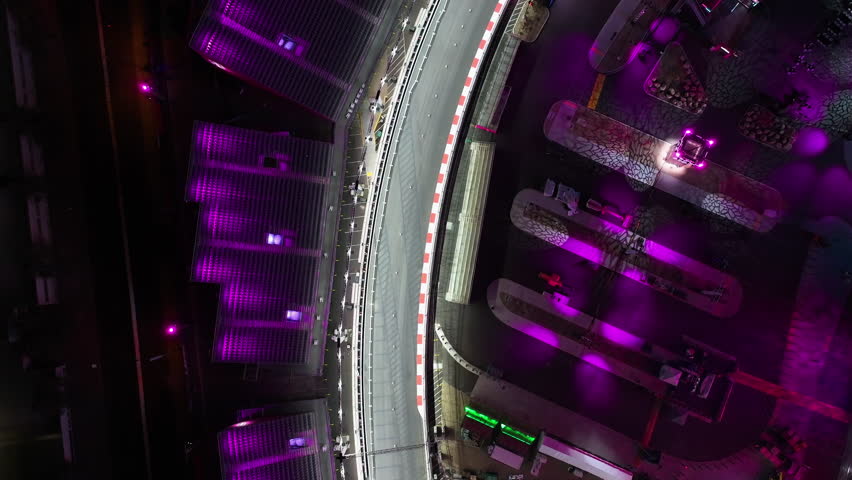 Birds eye aerial following a night lit racetrack in downtown Las Vegas, USA