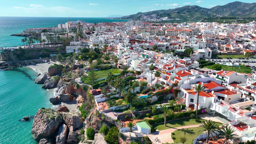 drone shot of Nerja, resort in southern Spain on the Mediterranean coast in Malaga, Nerja seaside town in Spain, luxury summer tourist destination . High quality 4k footage