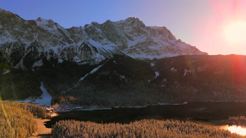 Breathtaking aerial view over snow-covered treetops in Germanys Bavarian Alps, showcasing Zugspitze massif. Zugspitze Gipfel highest peak of Wetterstein Mountains and highest mountain in Germany. 
