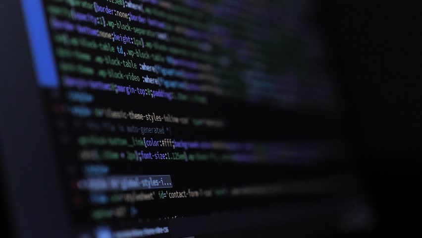 Developer is Browsing HTML Code on the Computer Screen. Side view. HTML Web Page Code Scrolling Programming, Abstract Technology Background for Software Developer, Computer Script Concept. Scene F.