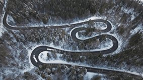 Winding road through snow-covered forest, aerial view of curves and turns - Powered by Shutterstock - Get 15% off with code: PIKWIZARD15