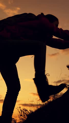Climbers silhouettes stretch their hands to each other, climbing to top of hill. Teamwork of business people. Team of businessmen, victory. Lend helping hand. Travelers climb one after another on rock