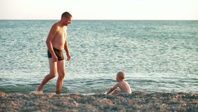 Father with kid on the summer beach