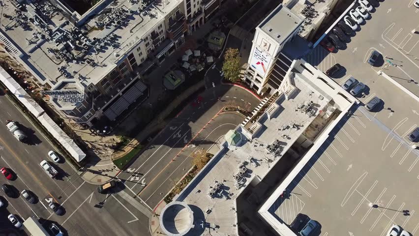 The Americana in Glendale, California with views of luxury pool in apartment complex. Aerial top down flyover shot. Pipelines on top of roofs.