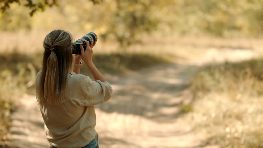 Tourist Photo Camera On Safari Masai Mara Kenya Safari.Professional Camera For Photograph Wildlife.  Safari In Savannah Photographer Takes Photo In Savannah. African Walking Safari. Kenya and Tanzania