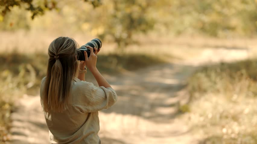 Tourist Photo Camera On Safari Masai Mara Kenya Safari.Professional Camera For Photograph Wildlife.  Safari In Savannah Photographer Takes Photo In Savannah. African Walking Safari. Kenya and Tanzania