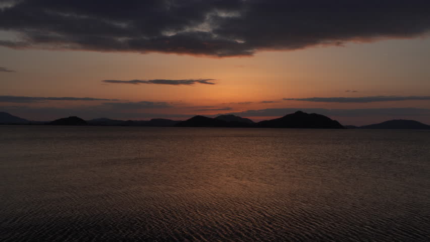 the sun is setting over the sea. Without sounds