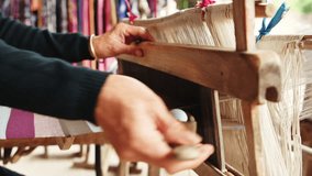 Discover the artistry of traditional weaving as skilled artisans manipulate threads on looms, creating stunning fabrics in a bright and inviting workshop atmosphere.
 - Powered by Shutterstock - Get 15% off with code: PIKWIZARD15