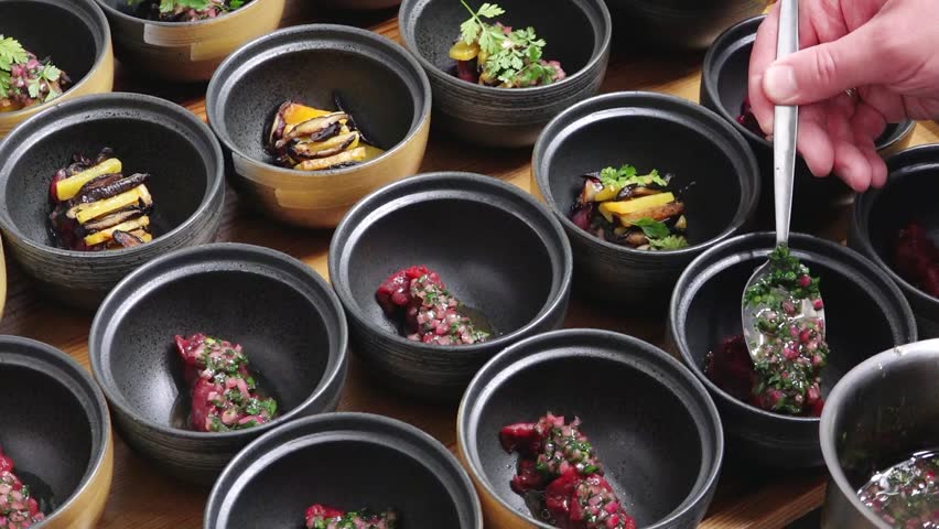Chef Preparing Gourmet Appetizers in Elegant Bowls for a Fine Dining Event