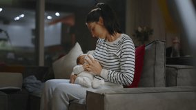 Authentic footage of a mother breastfeeding her newborn baby and drinking milk from a small bottle while lying in her mother's arms. Portrait of a Caucasian newborn baby at home.  - Powered by Shutterstock - Get 15% off with code: PIKWIZARD15