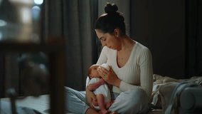 Authentic footage of a mother breastfeeding her newborn baby and drinking milk from a small bottle while lying in her mother's arms. Portrait of a Caucasian newborn baby at home.  - Powered by Shutterstock - Get 15% off with code: PIKWIZARD15