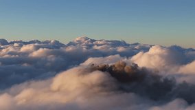 Volcan de Fuego explosive ash plume eruption at dawn, aerial view above the clouds with volcano cone concealed - Powered by Shutterstock - Get 15% off with code: PIKWIZARD15