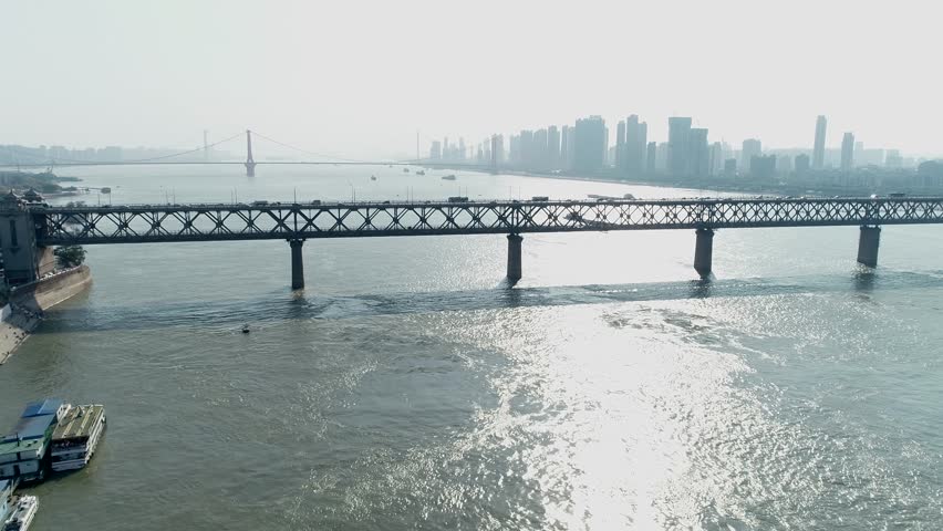Busy traffic on the Wuhan Yangtze River Bridge and the distant cityscape