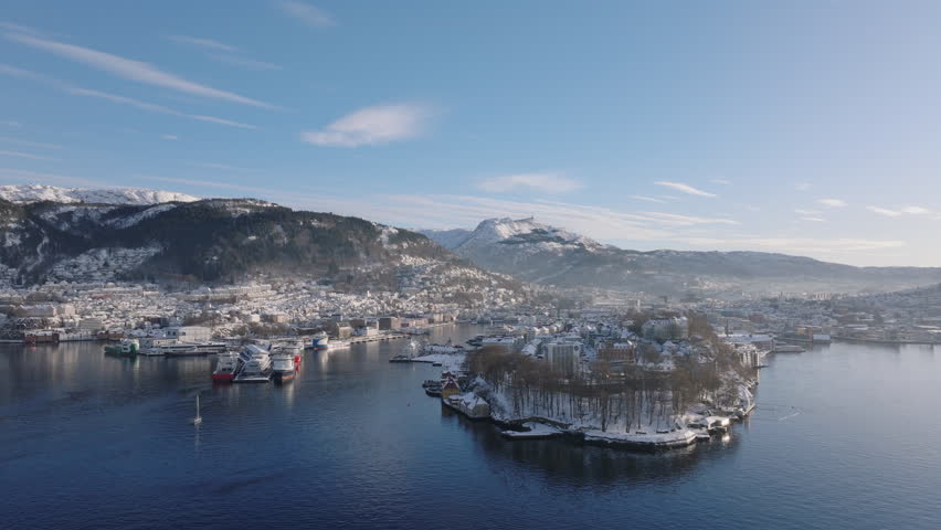 Panoramic aerial shot of downtown Bergen, the waterfront and the surrounding mountains on a sunny winter day