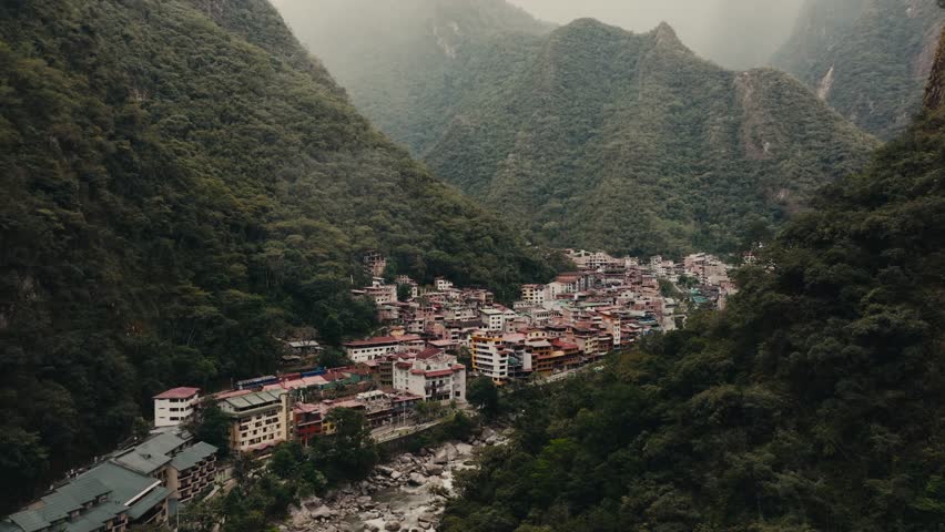 A Stunning Panorama of Machu Picchu, the City of Aguas Calientes, and the Urubamba River in Peru - Drone Flying Forward