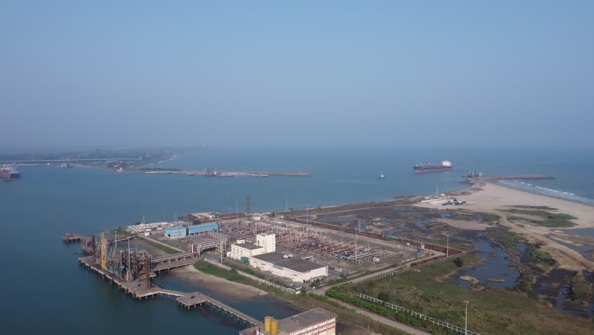 Ship entering port from the sea, view from drone. Aerial view of the bow of a large loaded container cargo ship entering port.