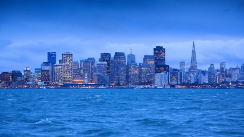 San Francisco skyline from twilight to night. View from Treasure Island. Timelapse.