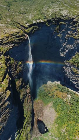Dramatic aerial ascend orbit of Cachoeira da Fumaça waterfall with double rainbows, Chapada Diamantina