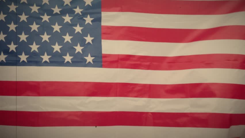 United States of America flag. Close up of United States flag waving in the wind. The stars and stripes ripple showing the patriotic red white blue colors. USA nation flag Symbol of freedom waving.