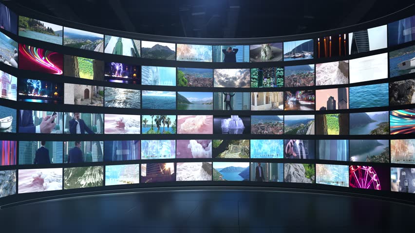 Large curved video wall displaying various video clips and images, including question marks, suggesting uncertainty or a quest for answers