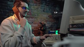 Young Man From 1990's Talking Over Speed Dial Landline Telephone in Front of Monitor of Desktop Computer - Powered by Shutterstock - Get 15% off with code: PIKWIZARD15